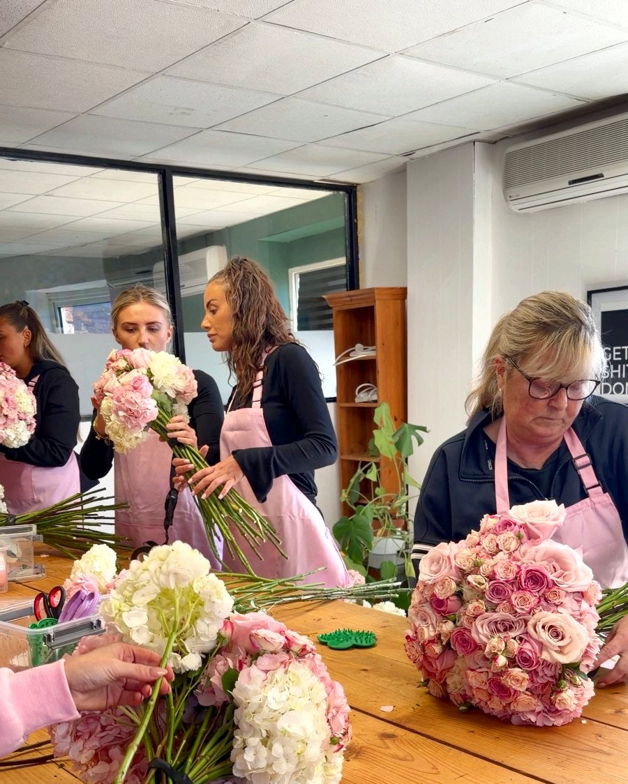 Everyone building their bouquets around the table