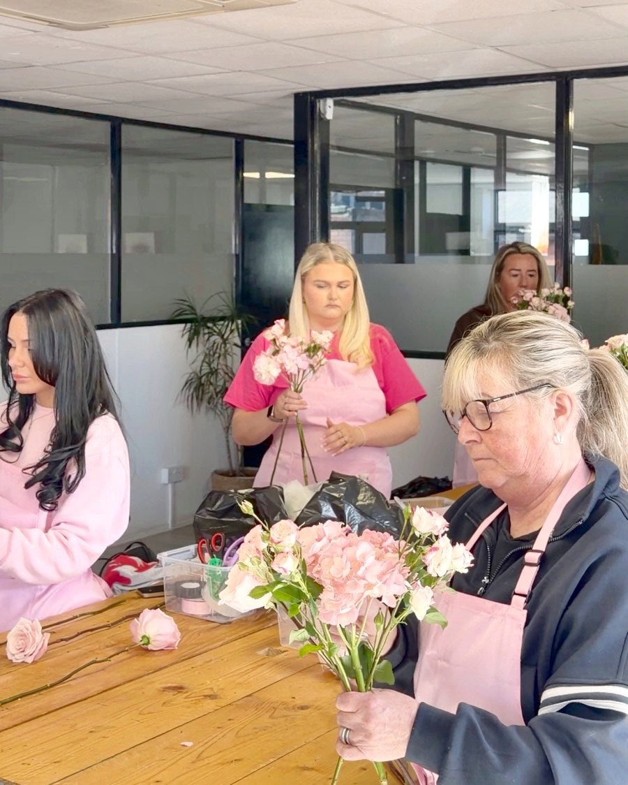 Building bouquets together at a group table