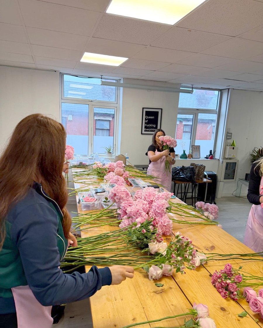 Everyone building their flowers along the long workshop table
