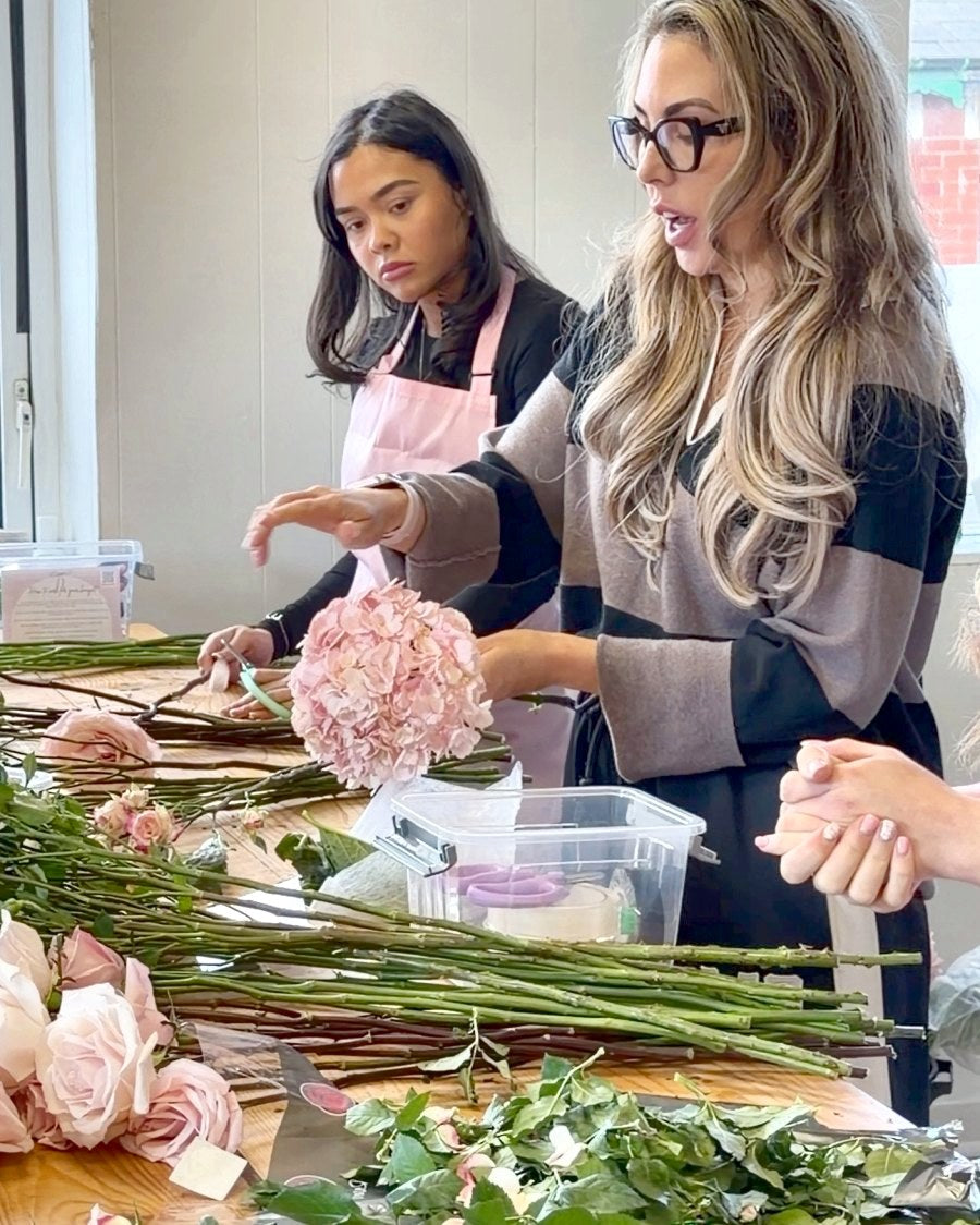Our tutor helping a student with a pink hydrangea bouquet