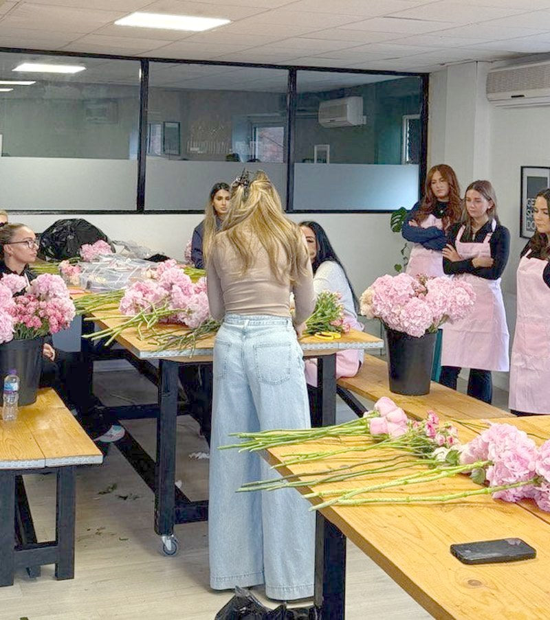 A full studio day, everyone building their flowers at the tables