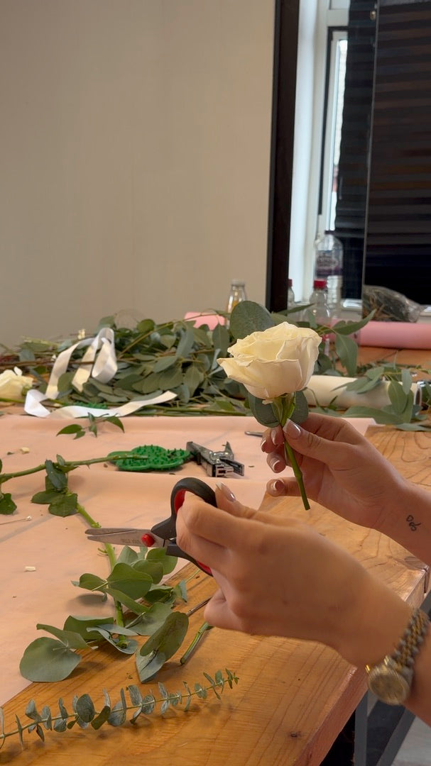 Preparing a white rose for a corsage