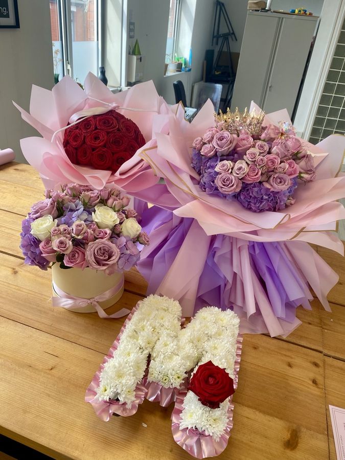 A letter M tribute with two bouquets