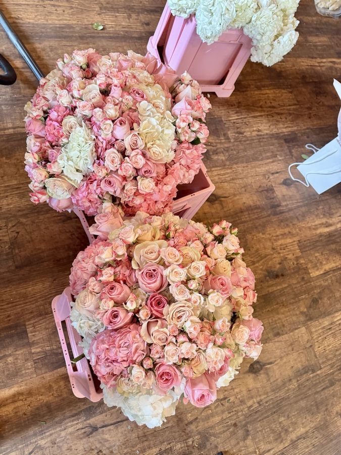 Two finished rose and hydrangea bouquets seen from above