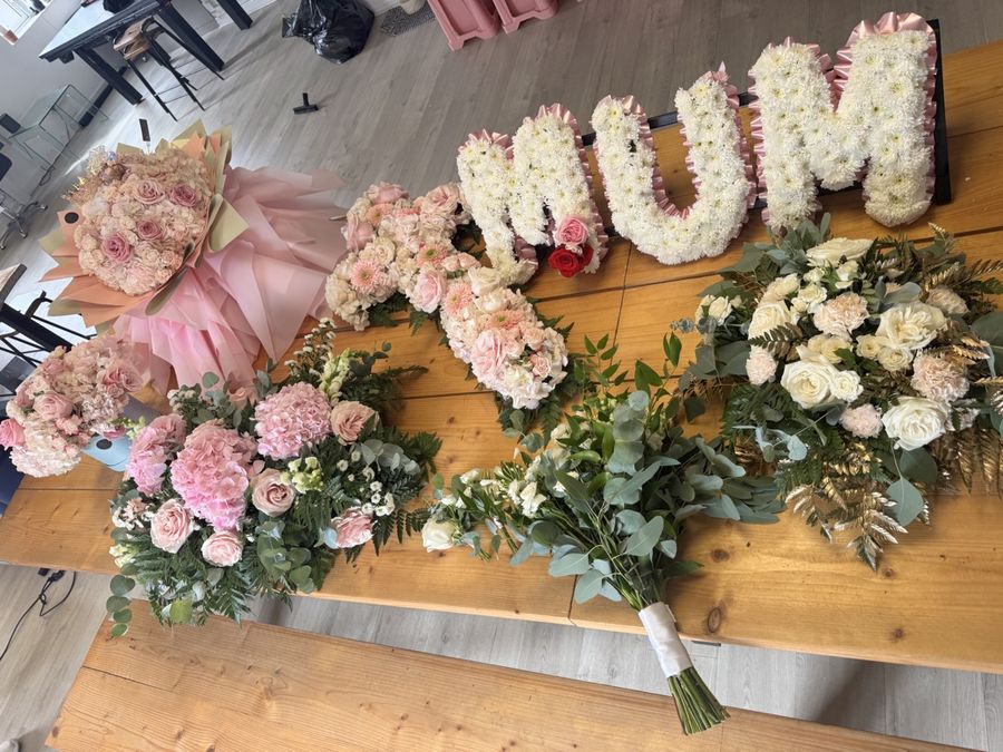 A MUM tribute and sprays laid out on the table