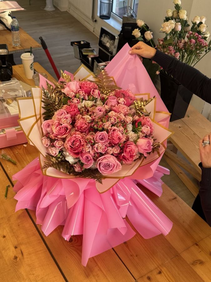 A pink rose bouquet on bright pink wrap
