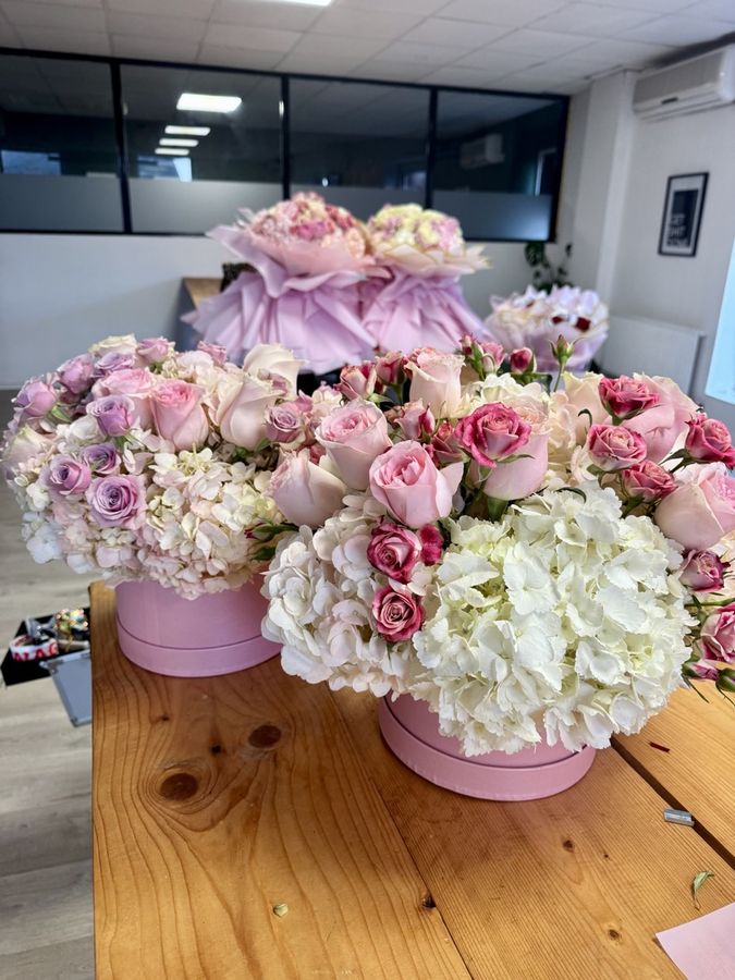 Hat boxes of roses and hydrangeas on the studio table