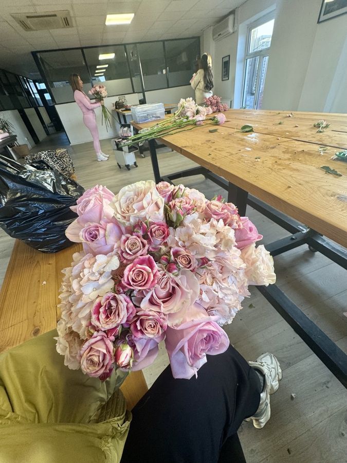 A rose and hydrangea bouquet held up close